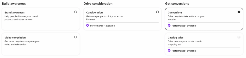 Interface showing marketing objectives: 'Build awareness' with options for brand awareness and video completion, 'Drive consideration' with option for consideration, and 'Get conversions' with options for conversions and catalog sales. 'Conversions' is selected, highlighted with a checkmark.